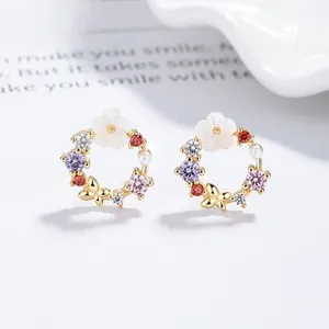 Macro shot of 925 silver flower stud earring with zircons and shell pearl inlay