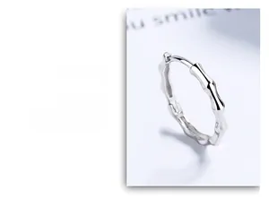 Detailed macro view of S925 sterling silver bamboo joint hoop earrings with polished finish