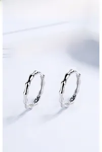 Detail shot of 925 sterling silver bamboo style hoop earrings with high polish finish