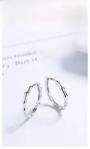 Detailed view of 925 sterling silver bamboo hoop earrings on clean white background