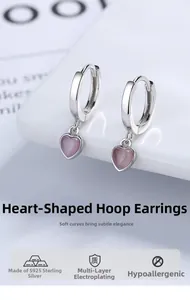 Detailed close-up of S925 sterling silver hoop earrings featuring pink cat-eye heart charms