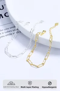 Detail of gold and silver S925 sterling silver paperclip chains with heart charm