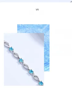 Detail view of s925 silver bracelet featuring blue crystals and elegant twisted leaf links