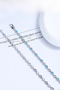Detailed shot of S925 silver bracelets with blue and white zircon stones on a white tray