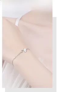 Detailed view of silver ginkgo leaf bracelet with mother of pearl inlay on model wrist
