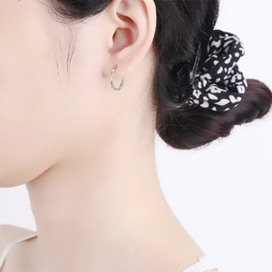 925 sterling silver bamboo textured hoop earrings on model showing minimalist style