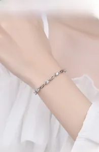 Close-up of s925 silver bracelet with sparkling blue crystals on female wrist