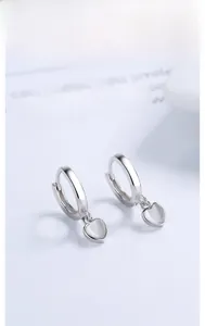 Close-up of S925 sterling silver heart-shaped moonstone hoop earrings on white background