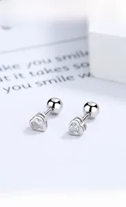 Gros plan de boucles d'oreilles cœur en argent avec zircon clair et fermoirs à vis ronds