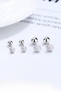 Macro detail of 925 sterling silver screw back earrings with matte finish and balls