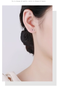 Gros plan sur les boucles d'oreilles nœud papillon en argent S925 et pavé de zircons