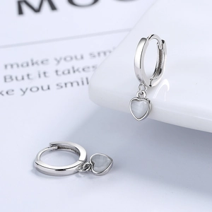 Elegant s925 silver heart hoop earrings with cat eye stones on a minimalist background