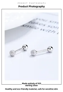 Macro detail of S925 sterling silver barbell earring with frosted and polished dual spheres