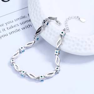 S925 sterling silver bracelet with blue crystal gems on elegant white porcelain plate