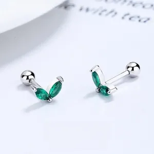 Detail of 925 silver sprout earrings with emerald green zircons and screw back closure