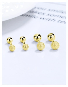 Close-up of S925 silver gold-plated ball stud earrings with matte and polished finishes