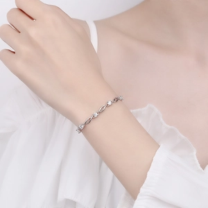 Elegant s925 silver bracelet featuring blue crystal and infinity links on a wrist