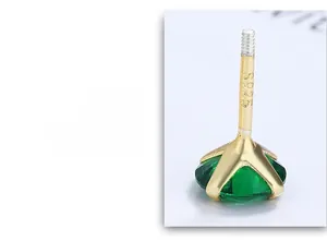 Macro view of four-prong emerald zircon stud earring in 925 sterling silver gold finish