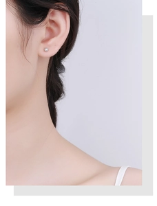 Close-up of 925 sterling silver ball stud earrings with a sparkling frosted texture