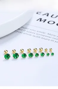 Set of eight emerald green zircon stud earrings in gold-tone with secure screw back closure