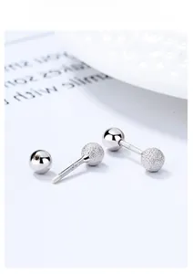 Macro shot of S925 sterling silver double-headed stud earrings with matte and polished beads