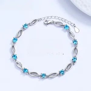 Detail view of the silver clover bracelet featuring ten circular blue crystals