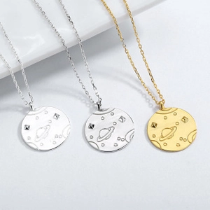 Detailed view of hollow planet universe pendants in silver and gold on fine chain