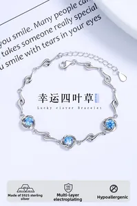Detail of s925 silver bracelet with blue crystal flowers and lucky clover design