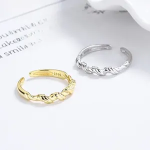 Detailed close-up of S925 sterling silver stamp on twisted rope texture open rings