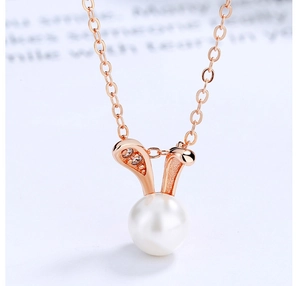 Macro shot of 925 sterling silver rabbit pearl pendant with rose gold finish