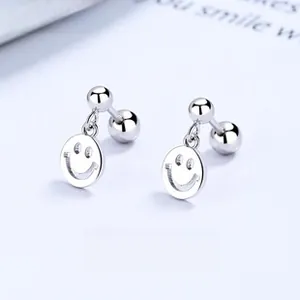 Macro detail of S925 sterling silver smile face stud earrings with screw back design