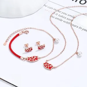 Close-up of red woven koi koi fish jewelry set with rose gold accents and pearls