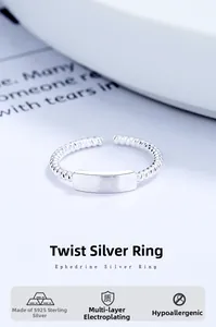 Detail of twisted 925 sterling silver ring with a smooth rectangle metal plate accent