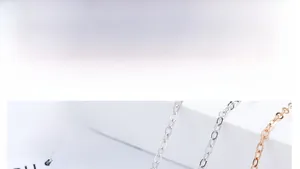 Close-up of silver and rose gold rabbit ear pendant necklaces with pearl detail