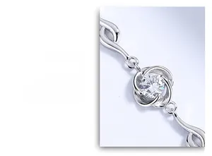 Detailed close-up of a S925 sterling silver four-leaf clover bracelet with blue crystal