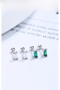 Macro view of rectangular emerald and clear crystal silver studs with screw backs