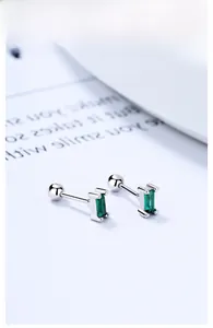Macro shot of 925 silver rectangular emerald stud earrings with screw-back closure