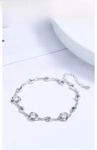 Detail of silver clover bracelet with three sparkling clear crystals and lobster clasp