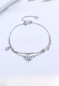 Detail of S925 sterling silver double-layer bracelet with moon and star charms