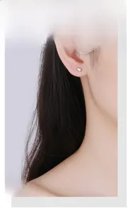Close-up of minimalist rectangular silver stud earring with clear zircon on ear