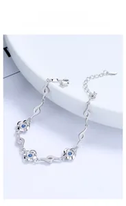 Detailed close-up of S925 silver four-leaf clover bracelet with blue zircon accents