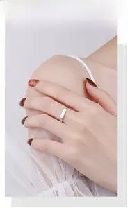 Close-up of twisted 925 sterling silver ring featuring a rectangular brushed metal plate