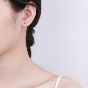 Minimalist 925 sterling silver hexagonal stud earring with a small zircon on ear lobe