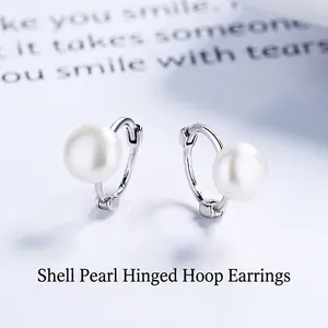Elegant s925 sterling silver hoop earrings with white shell pearls on a minimalist background