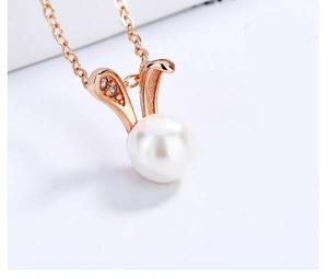 Macro shot of 925 silver rabbit pearl pendant with rose gold ears and zircon accents