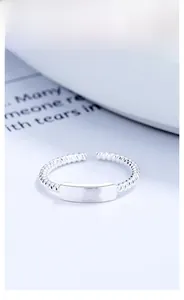 Macro shot of 925 sterling silver twisted rope ring with a smooth rectangular plaque detail