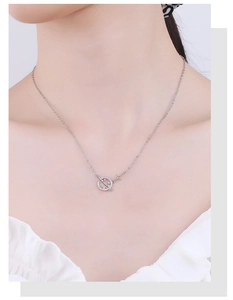 Detail of 925 silver planet necklace with pave zircon stones on a female neck