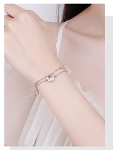 Detailed close-up of 925 sterling silver moon and star crystal bracelet on a wrist