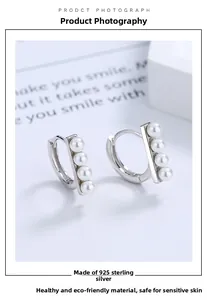 Detail of s925 sterling silver bar earrings with four pearls in a linear setting