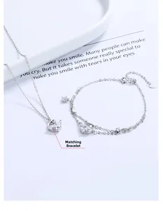 Detail shot of a double-layered S925 sterling silver bracelet with a crescent moon pendant